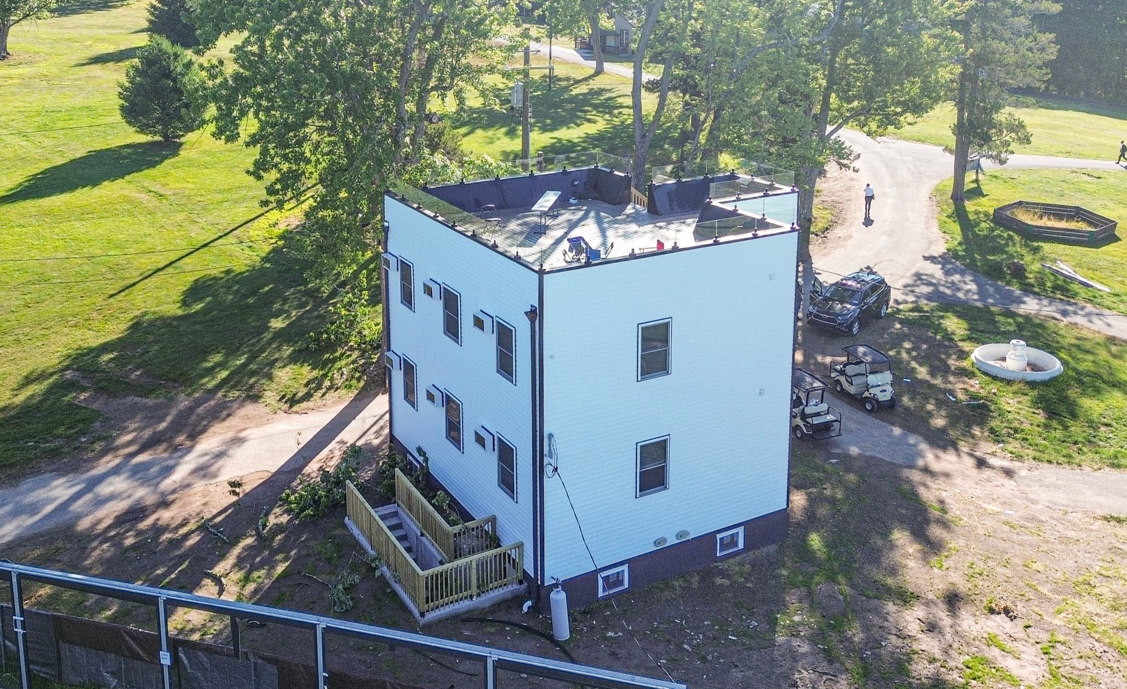 A dormitory shell from the air — three storeys framed, sheathed and windowed