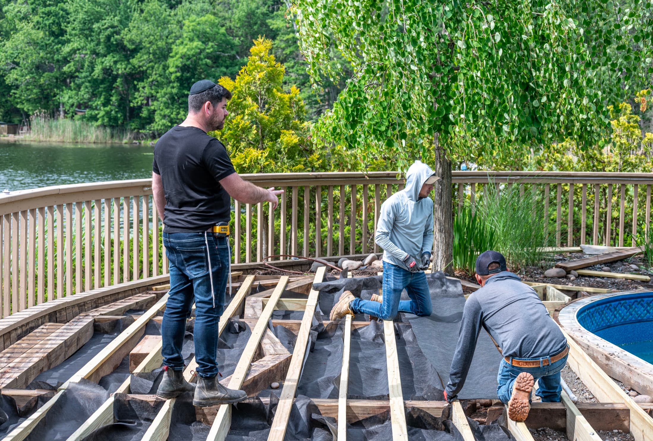 A pool deck being framed — joists set out on the radius of the pool before the decking goes down